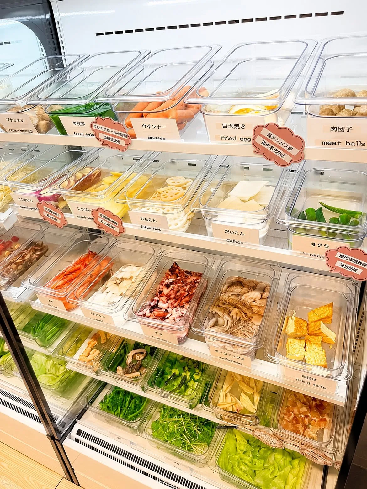 六美麻辣湯的配料櫃。冷藏展示櫃中陳列著鴻喜菇、鮮昆布、香腸、煎蛋、肉丸、蝦子、魷魚、章魚、綜合菇與炸豆腐等多種配料
